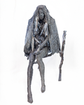 A life-sized sculpture of a seated mother holding her son close, constructed entirely from a lattice of welded dark iron nuts with a walking stick at her side, set against a plain background.